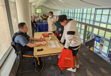 Students speak with a member of the law enforcement community at the Career Exploration Fair