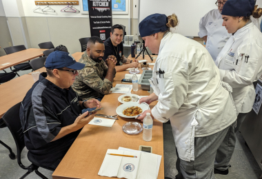 Burke and Carpenter present their dishes to the judges