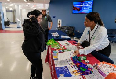 Atlantic Cape student browses the Center for Student Success table