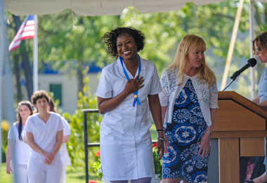 Nursing graduate accepts her medal and RN diploma