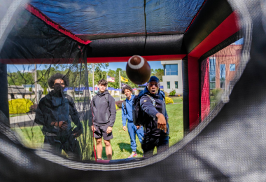 Students try out the inflatable football toss game with remarkable accuracy