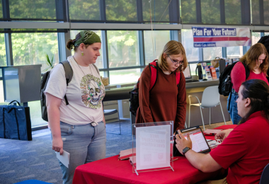 Two Atlantic Cape students speak to a college staff member