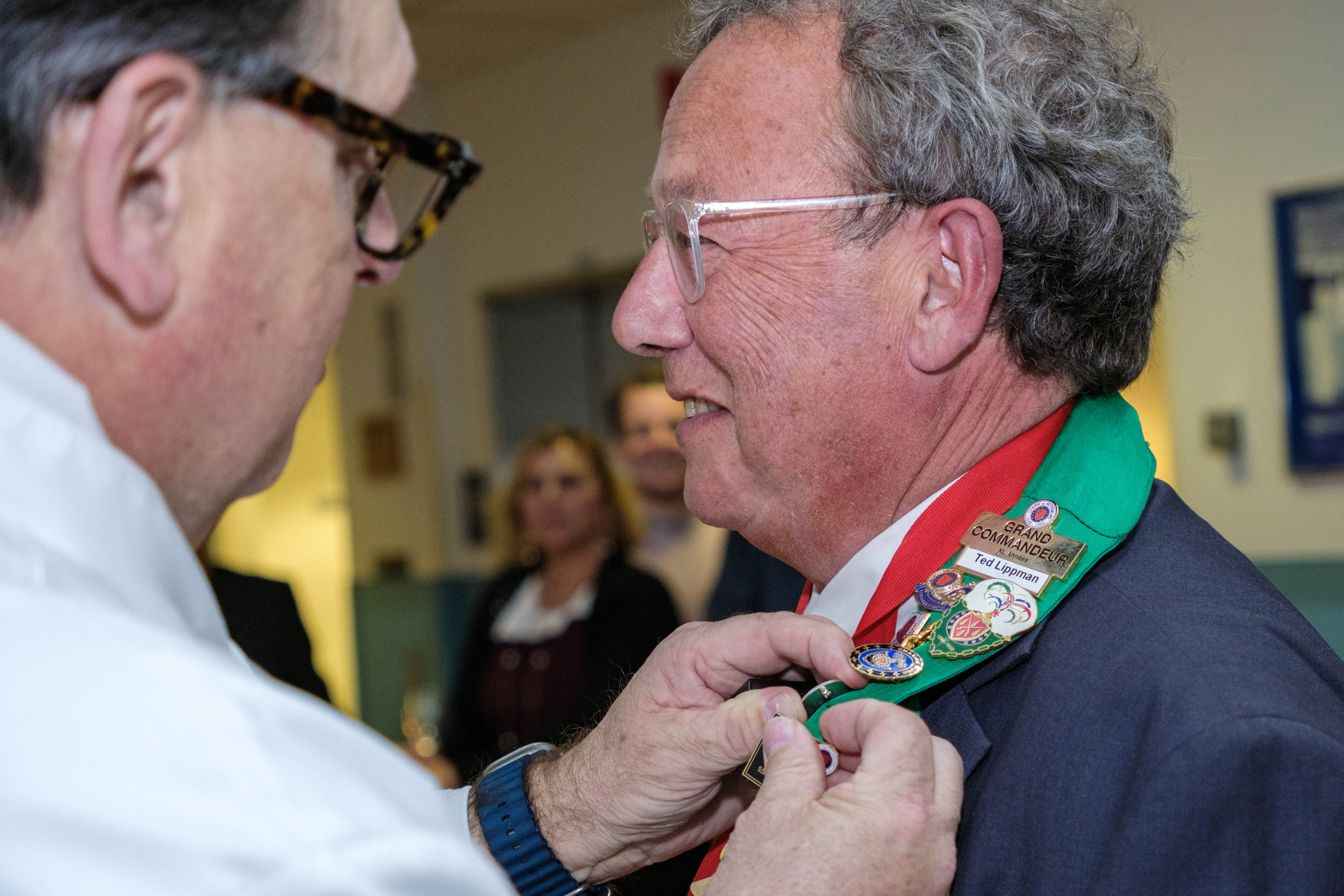 Honoree Ted Lippman receives his pin from Joseph Sheridan