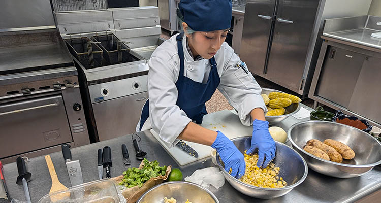 Student competing during DeFinis Scholarship Cooking Competition