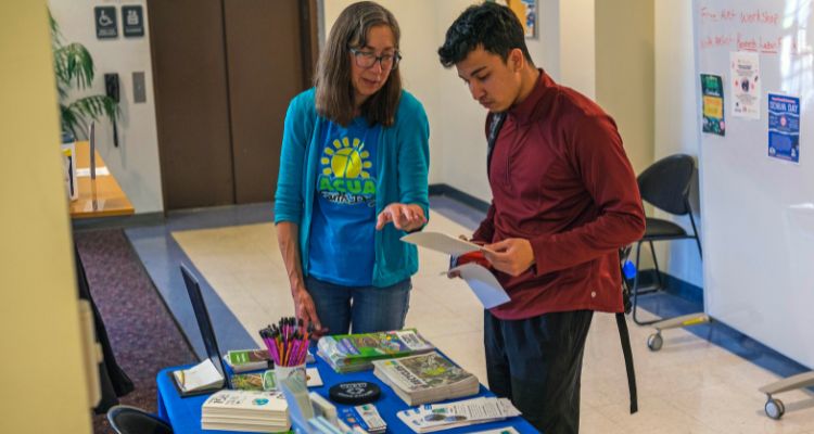 Atlantic Cape student speaks with a representative from the ACUA