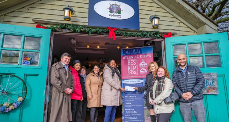 Republic Bank representative Christina Nugent presents Atlantic Cape's Dr. Natalie Devonish with a check for the Inlet CDC