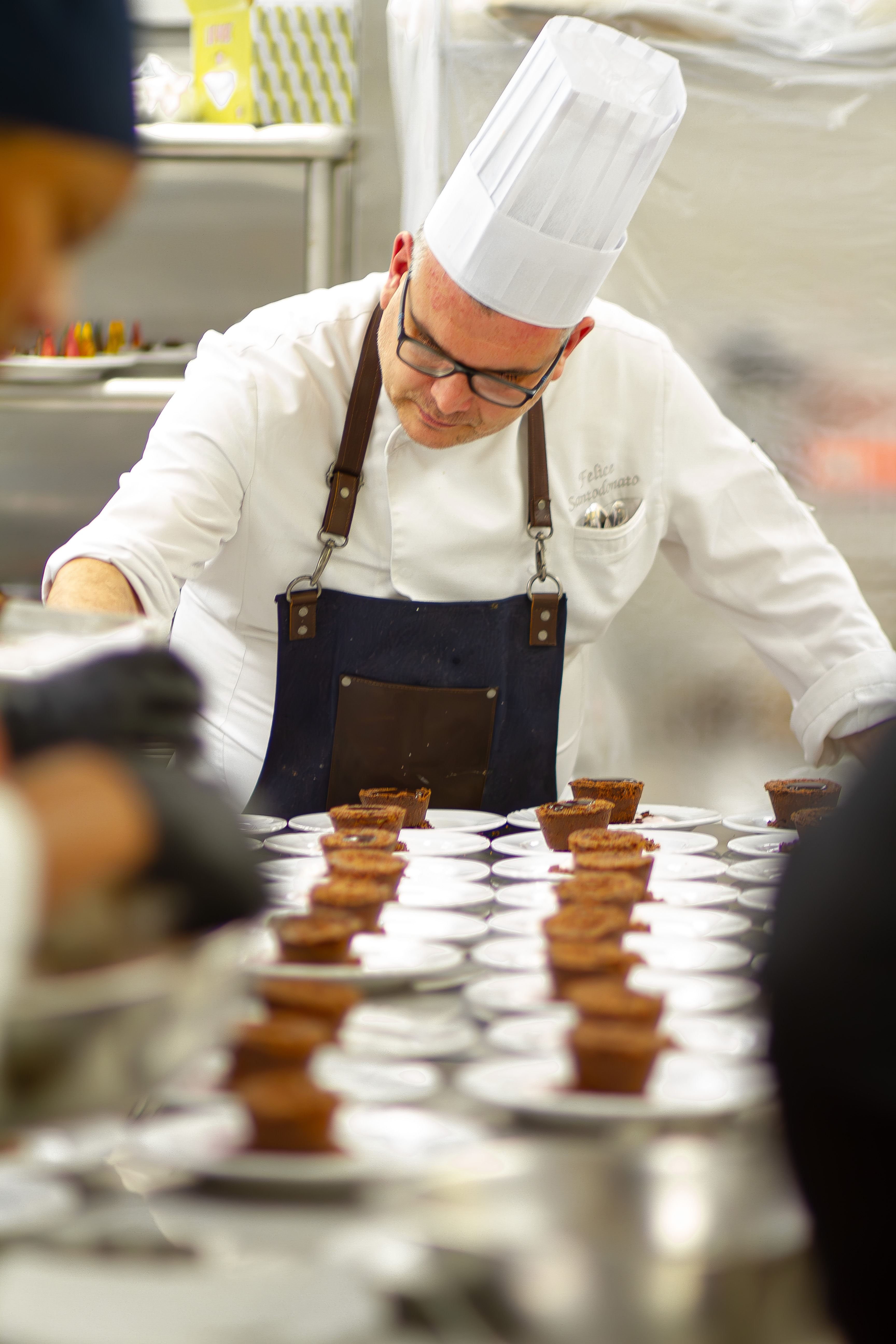 Chef Felice Santodonato preparing food for the fundraising dinner