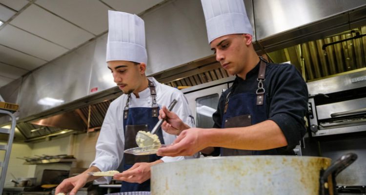 Preparing risotto during Italy dinner cooking demonstration