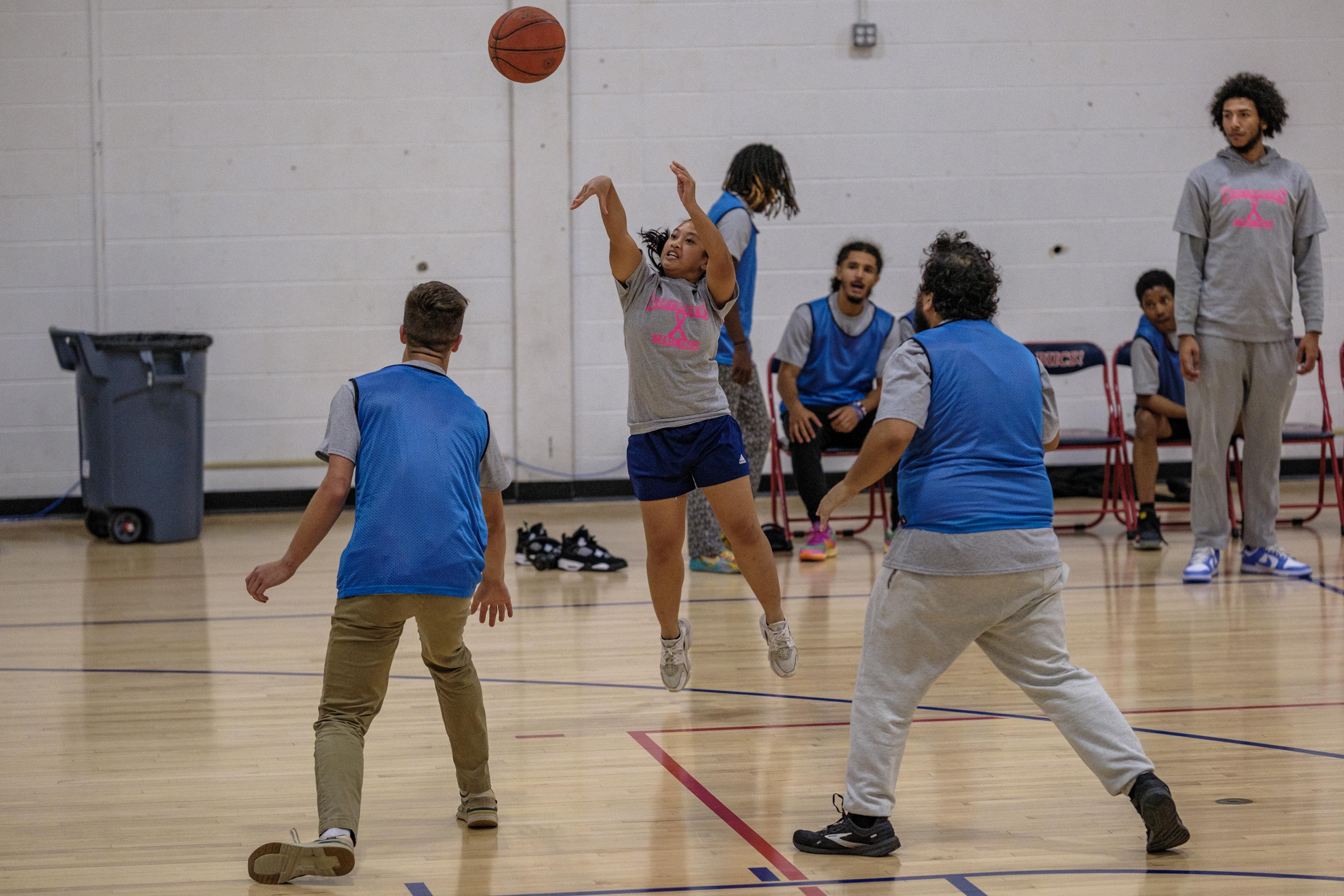 Student takes a shot during basketball game