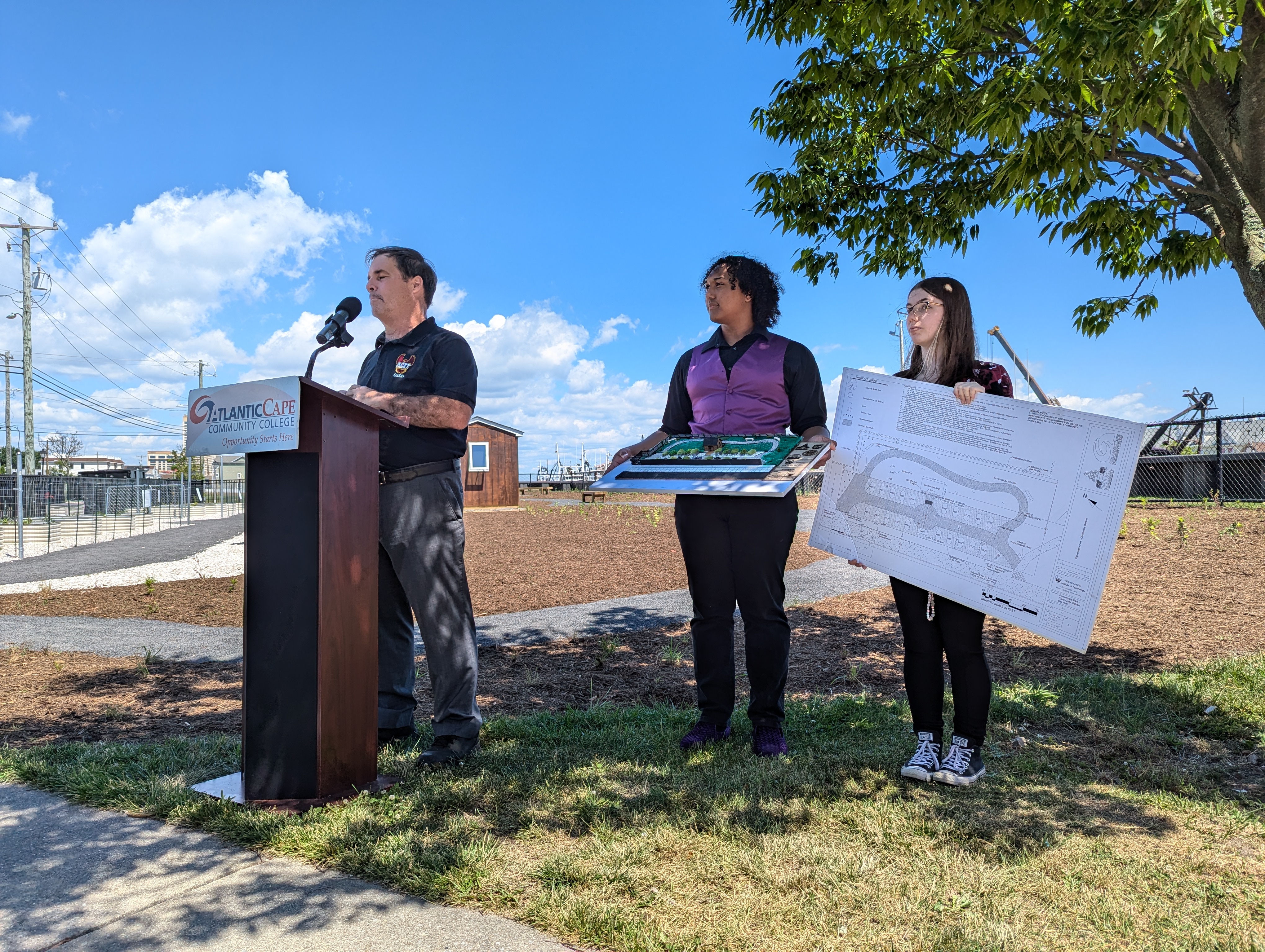 Students from ACIT display their drawing and model of the park