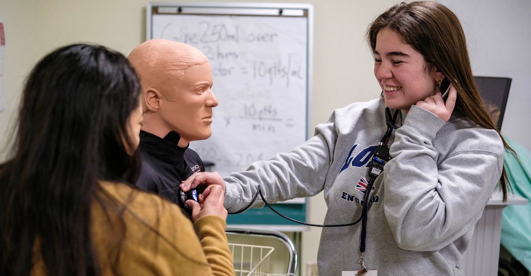 Student listens for a heartbeat during Health Science Day