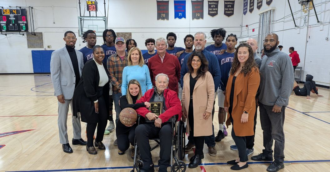 gathering at center court for a group photo during Robert Goudie ceremony