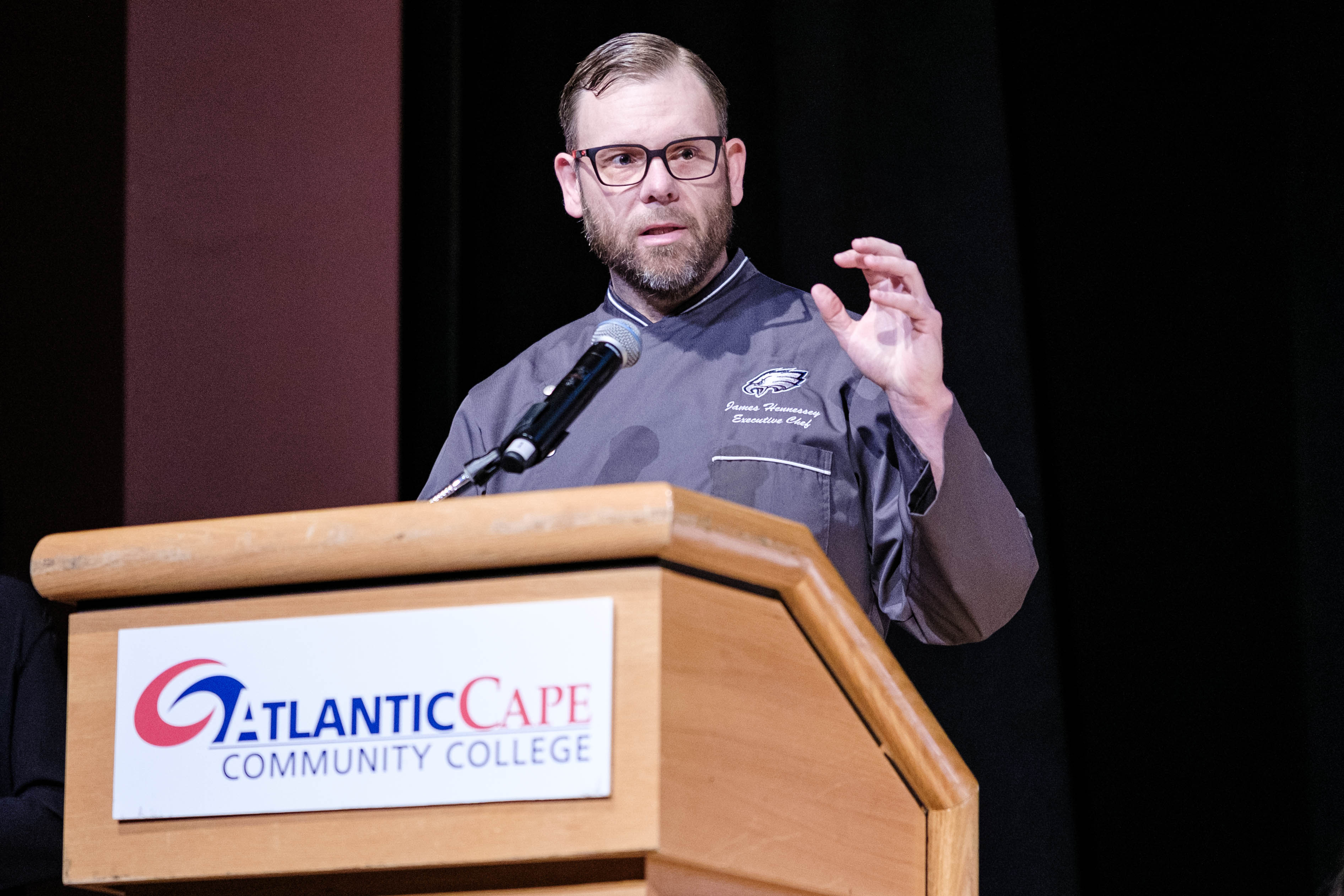 Executive Chef James Hennessey speaks to the audience and graduates