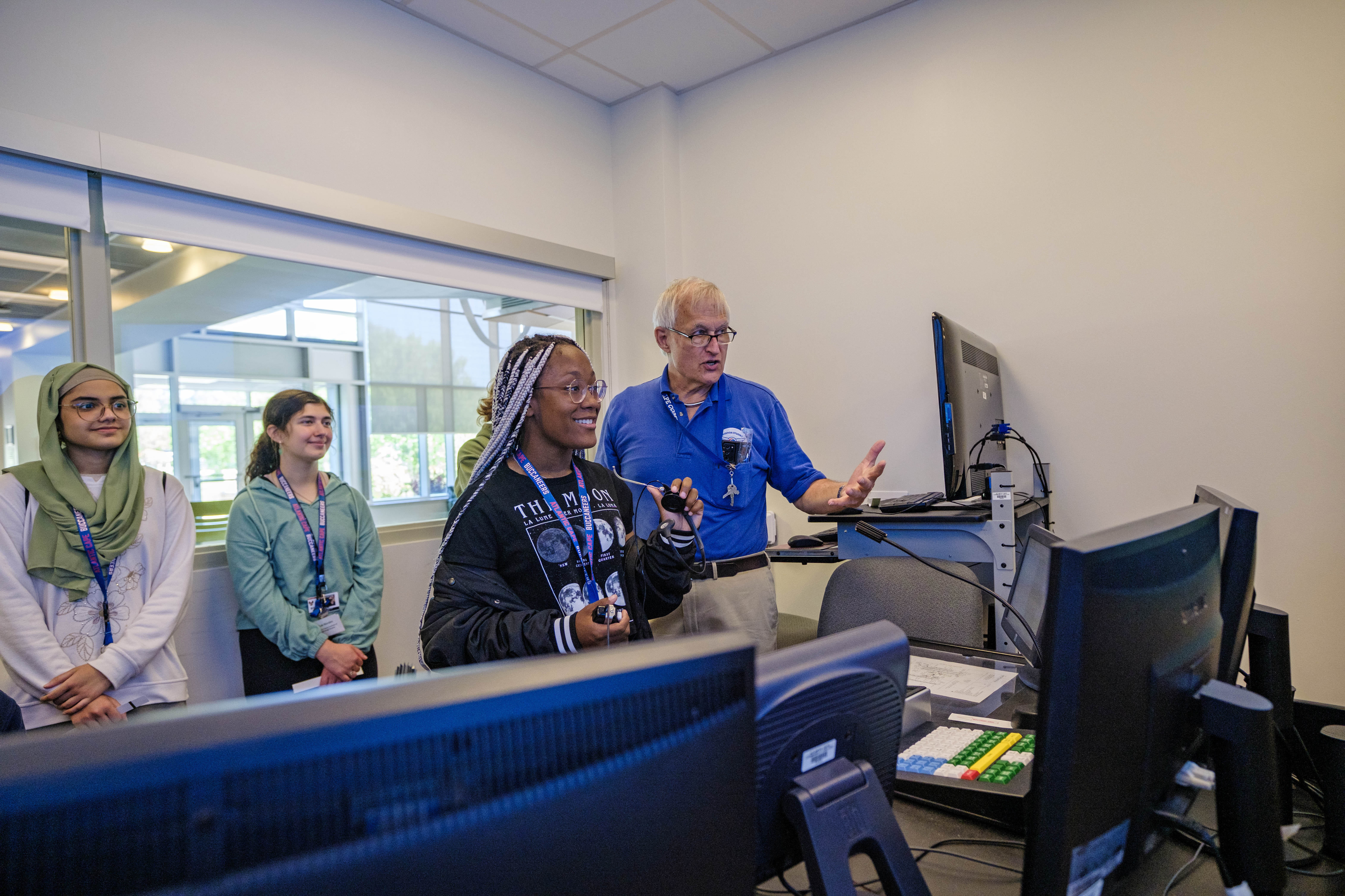 Professor Tim Cwik with students in the air traffic control simulator room